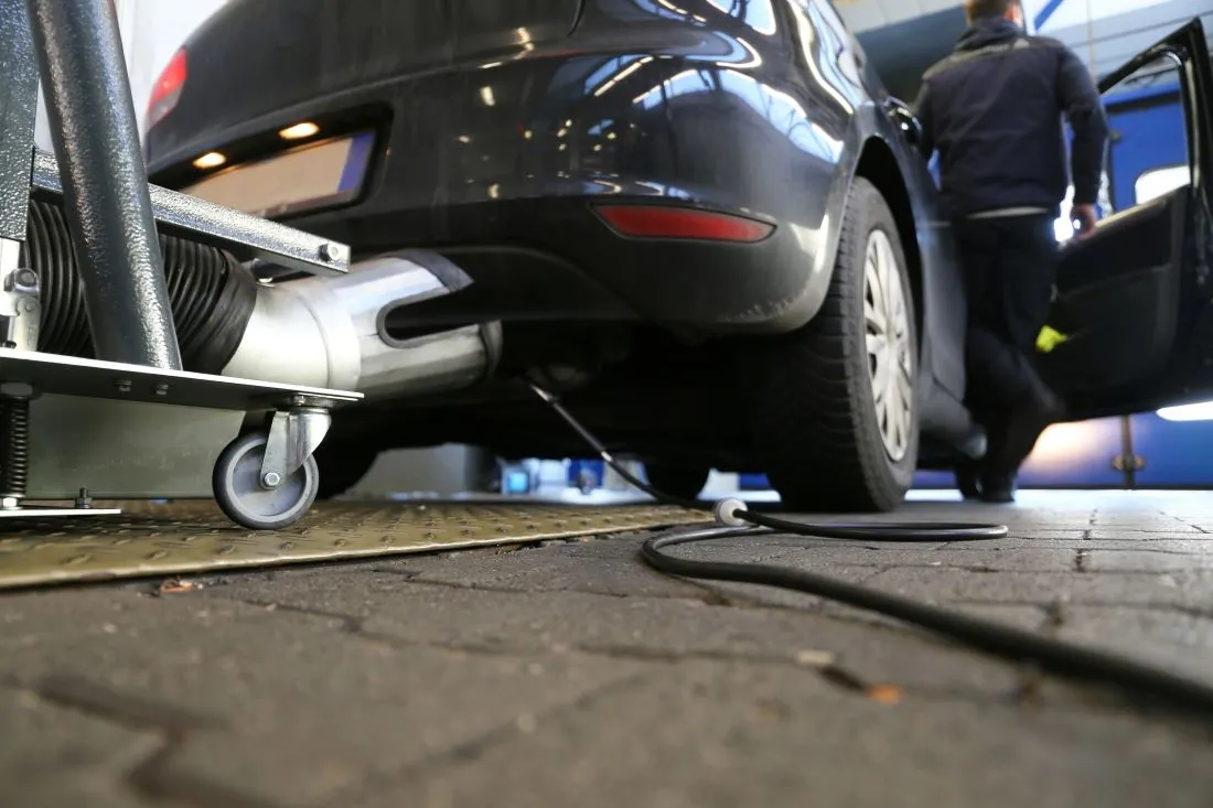 abgasuntersuchung Das Bild zeigt ein Auto, bei welchem eine Abgasuntersuchung durchgeführt wird.